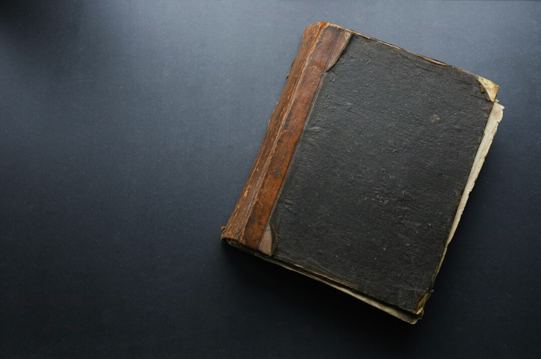 Old open book with yellowed pages on a table