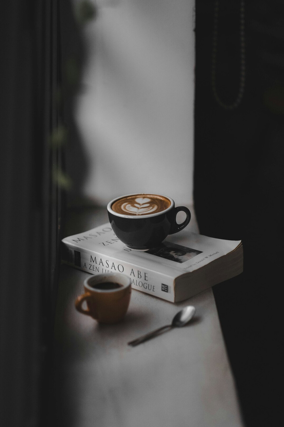 Books laid out flat with a cup of coffee